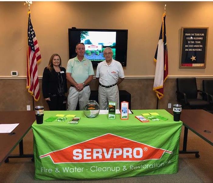 SERVPRO booth with three people