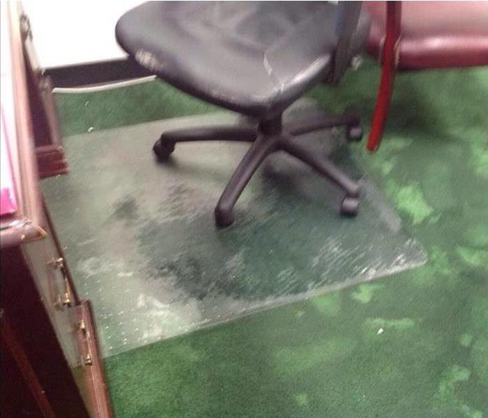 water on green carpeting with office chair